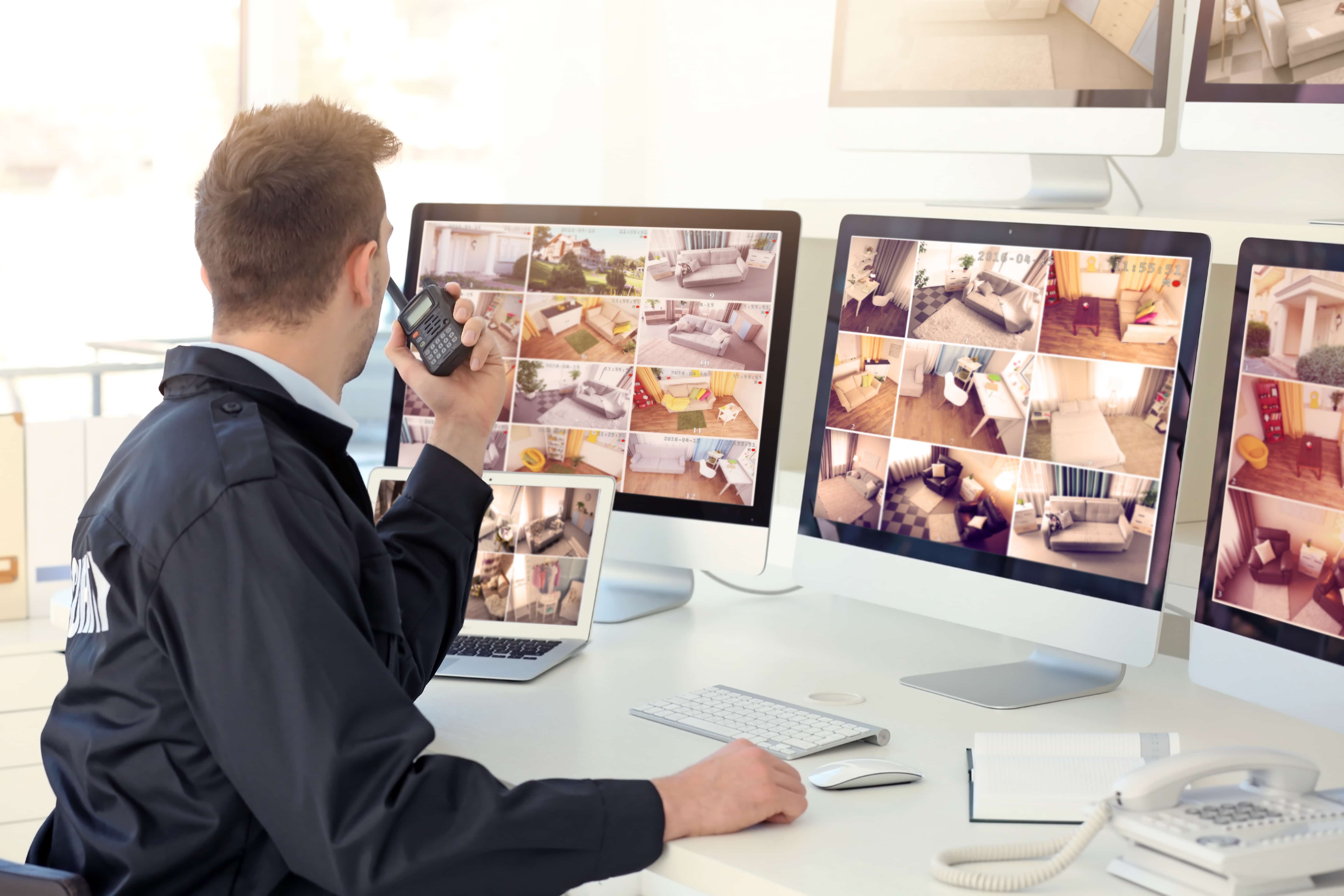 Image of a security manager viewing live PoE camera footage.